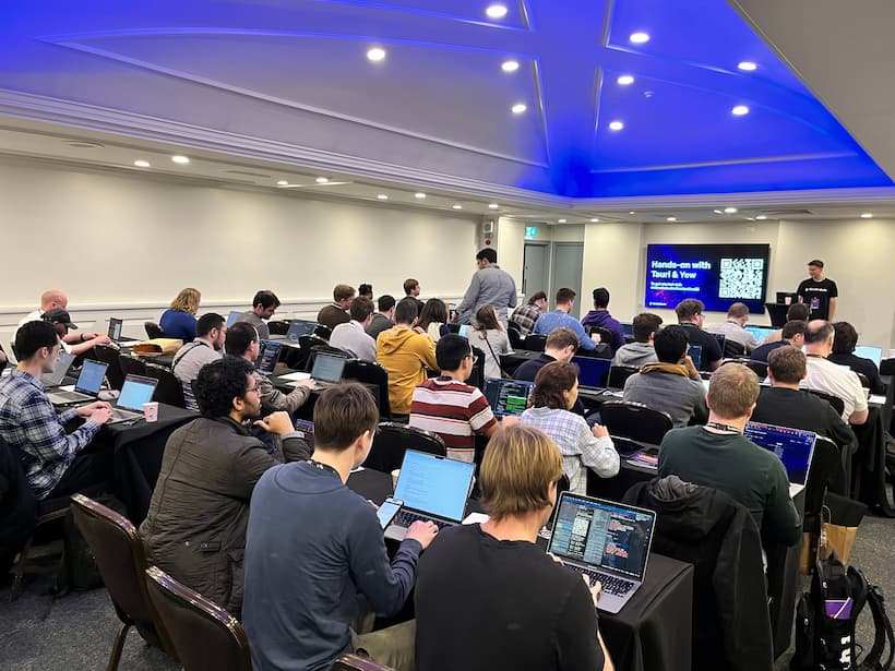 A full-room view of the workshop, with dozens of developers listening to Jonas.